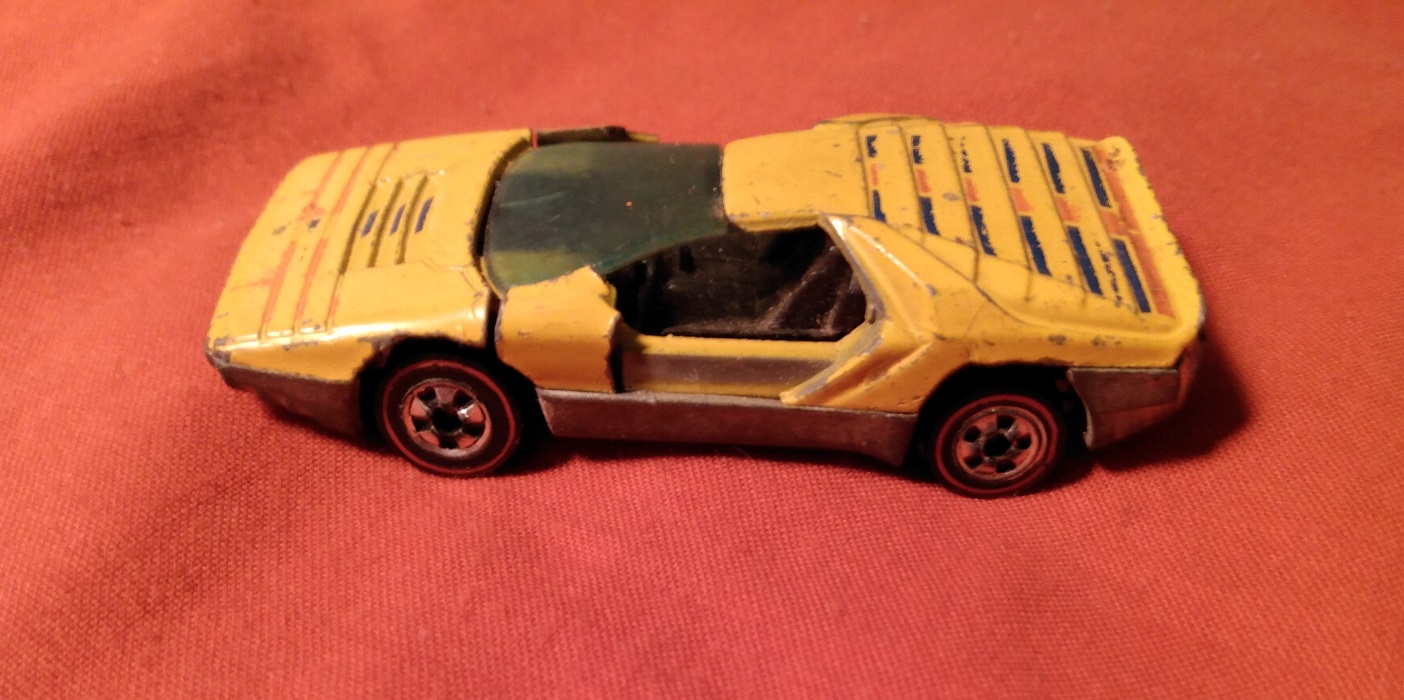 YELLOW HOT WHEELS CARABO WITH DOORS BROKEN OFF