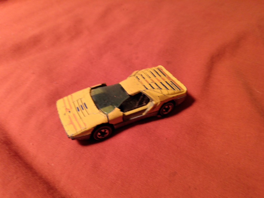 YELLOW HOT WHEELS CARABO WITH DOORS BROKEN OFF