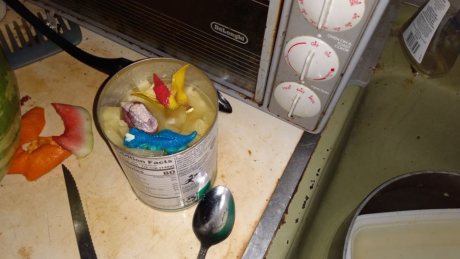 DINOSAUR HOLDING AN ORANGE