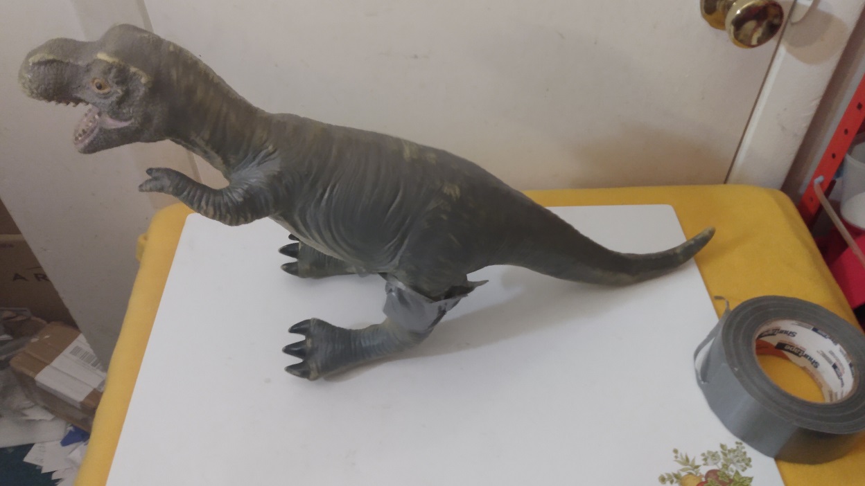 DINOSAUR WITH LEGS DUCT TAPED ON