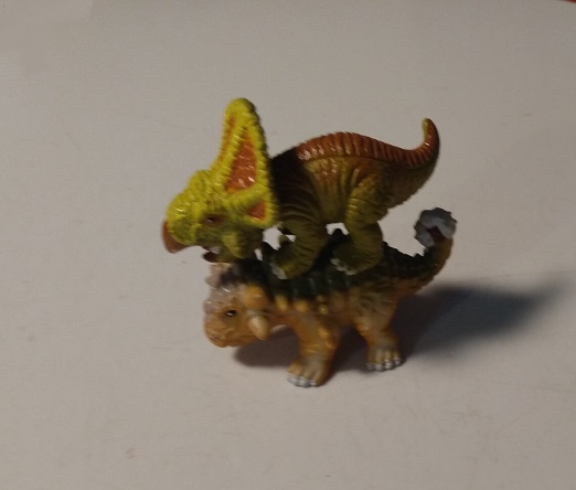 PROTOCERATOPS ON TOP OF AN ANKYLOSAURUS