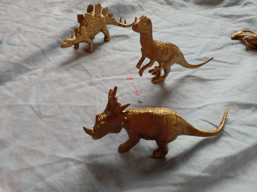 GOLD DINOSAURS AND A STRAY ANT