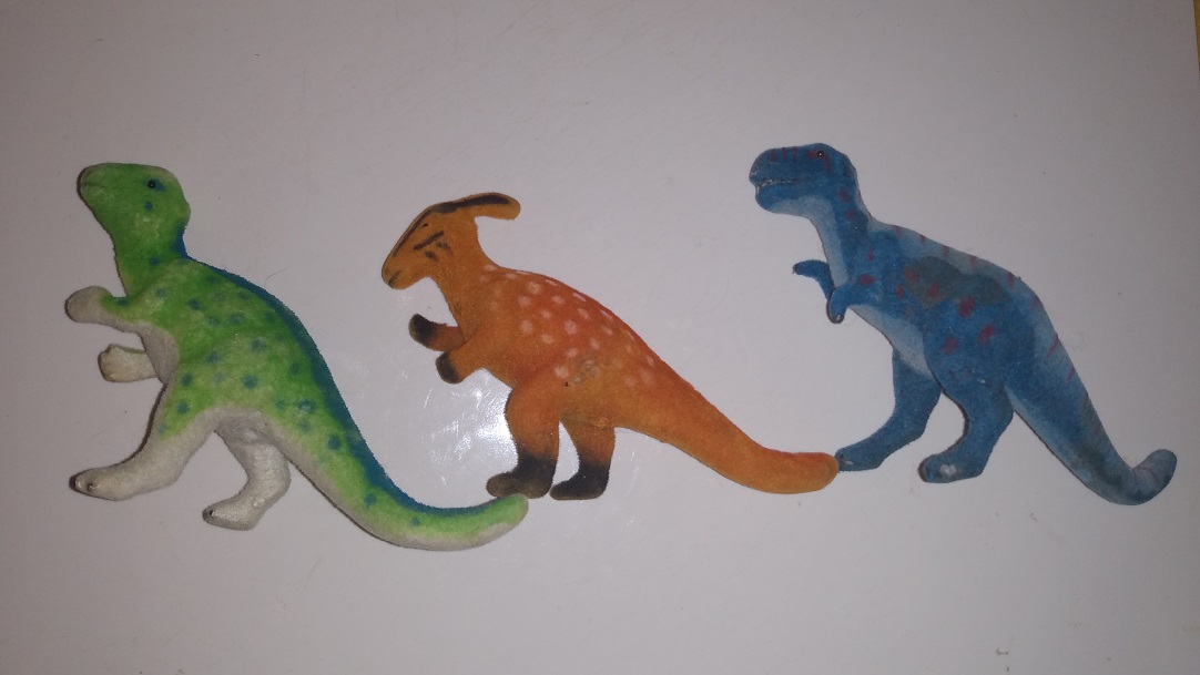 THREE FLOCKED DINOSAURS