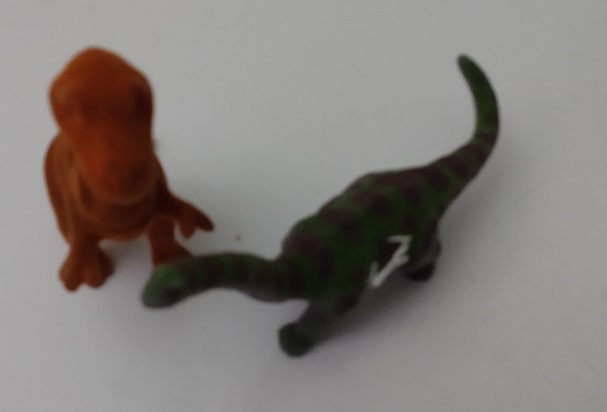TWO FLOCKED DINOSAURS