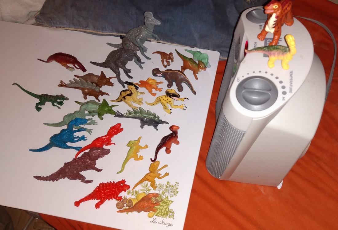 DINOSAURS WARMING UP WITH A PORTABLE HEATER