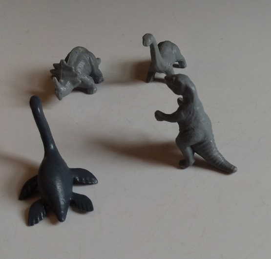 FOUR KELLOGGS DINOSAUR FIGURES