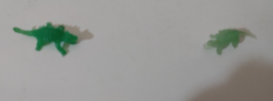 TWO GREEN TRANSPARENT DINOSAURS