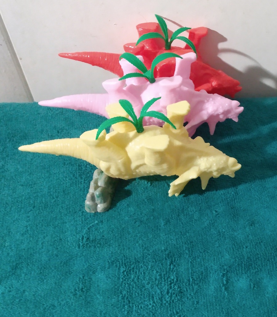 TRICERATOPS PLANTERS WITH PLASTIC PLANTS INSERTED WRONG